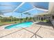 Sparkling in-ground pool with a screened enclosure and spacious patio area, ideal for summer fun at 25449 Doredo Dr, Punta Gorda, FL 33955
