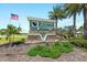 Community entrance sign for Burnt Store Village, a deed restricted community, with lush landscaping at 25449 Doredo Dr, Punta Gorda, FL 33955