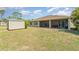 Large, grassy backyard with storage shed and a screened-in patio at 2707 Auburn Blvd, Port Charlotte, FL 33948