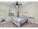 A cozy bedroom features a large window and a bright colorful bed with soft natural light at 2707 Auburn Blvd, Port Charlotte, FL 33948