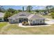 Charming home exterior with manicured landscaping, a well-maintained lawn, and inviting curb appeal at 2707 Auburn Blvd, Port Charlotte, FL 33948