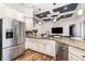 Charming kitchen boasts granite countertops, stainless steel appliances, and custom cabinetry with a tray ceiling at 2707 Auburn Blvd, Port Charlotte, FL 33948