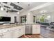 Bright kitchen showcasing stainless steel appliances, granite countertops, and seamless layout to other rooms at 2707 Auburn Blvd, Port Charlotte, FL 33948