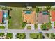 Aerial view showcases a tiled-roof house with a canal front, private pool, and well-kept lawn at 2719 Mayaguana Ct, Punta Gorda, FL 33950