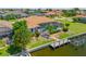 Aerial back view showcases a pool, spa, lanai, lush tropical landscaping, canal, and boat dock at 2719 Mayaguana Ct, Punta Gorda, FL 33950