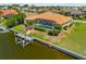 Aerial rear view showcases a pool in screened-in patio with a canal view and a boat dock at 2719 Mayaguana Ct, Punta Gorda, FL 33950