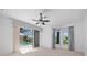 Bedroom with bright carpet, ceiling fan, and natural light from multiple windows and glass doors at 2719 Mayaguana Ct, Punta Gorda, FL 33950