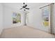 Bedroom featuring bright carpet, a ceiling fan, and multiple windows with shutter-style blinds at 2719 Mayaguana Ct, Punta Gorda, FL 33950
