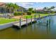 Dock and boat lift on a canal featuring waterside views and manicured landscaping at 2719 Mayaguana Ct, Punta Gorda, FL 33950