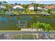 Wide canal view featuring private boat lift and dock with access to the open water at 2719 Mayaguana Ct, Punta Gorda, FL 33950
