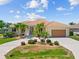 Beautiful home with a circular driveway, lush landscaping, and a well-maintained lawn at 2719 Mayaguana Ct, Punta Gorda, FL 33950