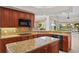 Updated kitchen with granite countertops, central island, and modern black appliances at 2719 Mayaguana Ct, Punta Gorda, FL 33950