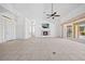 Bright, open living area with fireplace, tile floors, and access to outdoor pool at 2719 Mayaguana Ct, Punta Gorda, FL 33950