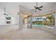 Bright living room with fireplace, tile flooring, and views of the screened-in pool and outdoor area at 2719 Mayaguana Ct, Punta Gorda, FL 33950