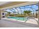 Inviting screened-in pool area with a relaxing pool and spa combination at 2719 Mayaguana Ct, Punta Gorda, FL 33950