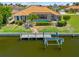 Waterfront home featuring a private boat dock, boat lift, screened lanai, and swimming pool at 2719 Mayaguana Ct, Punta Gorda, FL 33950