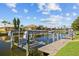 Picturesque canal with boat lifts and docks amidst beautiful waterfront homes and clear blue skies at 2719 Mayaguana Ct, Punta Gorda, FL 33950