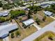 Aerial view of a fenced single-Gathering home in a serene neighborhood, surrounded by lush trees at 281 Seminole Nw Blvd, Port Charlotte, FL 33952