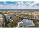Wide aerial view of a residential community showing the neighborhood layout, surrounding landscape, and nearby waterways at 2913 Royal Palm Dr, North Port, FL 34288
