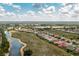 A high aerial shot captures a residential community with lake views, highlighting the neighborhood's layout and landscaping at 2913 Royal Palm Dr, North Port, FL 34288