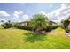 Beautifully landscaped backyard with lush greenery and a well maintained lawn for outdoor activities and relaxation at 2913 Royal Palm Dr, North Port, FL 34288