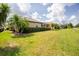Spacious backyard with a well-kept lawn, and privacy hedging for outdoor enjoyment and relaxation at 2913 Royal Palm Dr, North Port, FL 34288