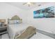Relaxing bedroom featuring a comfortable bed, ceiling fan, and charming coastal artwork at 2913 Royal Palm Dr, North Port, FL 34288