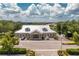 Exterior view of community center, showcasing manicured landscaping, ample parking, and inviting entrance at 2913 Royal Palm Dr, North Port, FL 34288
