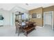 Dining area with a wooden table, bench seating, stylish lighting, and sliding doors to the outdoor space at 2913 Royal Palm Dr, North Port, FL 34288