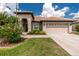 Charming single-story home featuring a tile roof, two-car garage and well-maintained landscaping at 2913 Royal Palm Dr, North Port, FL 34288