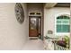 Inviting front entrance features a wood door with glass panels, decorative wreath, and cozy seating area at 2913 Royal Palm Dr, North Port, FL 34288