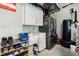 Well-equipped garage featuring utility sink, white cabinetry, storage space, epoxy flooring and refrigerator at 2913 Royal Palm Dr, North Port, FL 34288