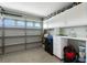Well-organized garage with storage cabinets, work bench, epoxy flooring, and natural light at 2913 Royal Palm Dr, North Port, FL 34288