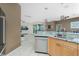 Kitchen with granite countertops, stainless steel dishwasher, and ample cabinet space at 2913 Royal Palm Dr, North Port, FL 34288
