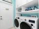Functional laundry room with modern washer/dryer, ample storage, and convenient access at 2913 Royal Palm Dr, North Port, FL 34288