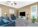 Cozy living room featuring a comfortable sofa, a large screen TV and a ceiling fan at 2913 Royal Palm Dr, North Port, FL 34288