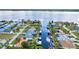 Aerial view of waterfront homes with boat docks and canal access to the bay, surrounded by lush landscaping at 3058 Curry Ter, Port Charlotte, FL 33981