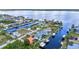 Aerial view of waterfront homes with private boat docks on a canal community near the bay under sunny skies at 3058 Curry Ter, Port Charlotte, FL 33981