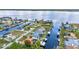 Aerial view of waterfront community with canal access, private docks, and beautiful landscaping along the water at 3058 Curry Ter, Port Charlotte, FL 33981