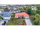 Beautiful waterfront property featuring a red roof, lush landscaping, and direct canal access at 3058 Curry Ter, Port Charlotte, FL 33981