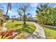 Beautiful backyard with lush green lawn and a convenient boat dock at 3058 Curry Ter, Port Charlotte, FL 33981
