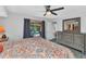 A spacious bedroom showing a dresser, access to the bathroom, and a view of the pool at 3058 Curry Ter, Port Charlotte, FL 33981