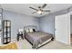 Cozy bedroom featuring light blue walls and a modern ceiling fan at 3058 Curry Ter, Port Charlotte, FL 33981