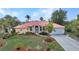 Charming single-story home with a vibrant red roof, well-maintained landscaping, and attached garage at 3058 Curry Ter, Port Charlotte, FL 33981