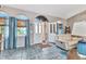 Foyer with arched windows, blue curtains, tile flooring, and a comfortable white recliner at 3058 Curry Ter, Port Charlotte, FL 33981