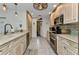 Well-lit kitchen featuring custom cabinets, stainless steel appliances, and tile backsplash at 3058 Curry Ter, Port Charlotte, FL 33981