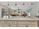 Open-concept kitchen with granite countertops and stainless steel appliances overlooking the living area at 3058 Curry Ter, Port Charlotte, FL 33981