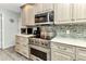 Bright kitchen featuring stainless steel appliances, elegant countertops, and tiled backsplash at 3058 Curry Ter, Port Charlotte, FL 33981