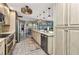 Bright kitchen with modern appliances and ample counter space, leading to a dining area with water views at 3058 Curry Ter, Port Charlotte, FL 33981