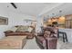 Comfortable living room featuring modern lighting, furniture, and an adjacent breakfast bar area at 3058 Curry Ter, Port Charlotte, FL 33981